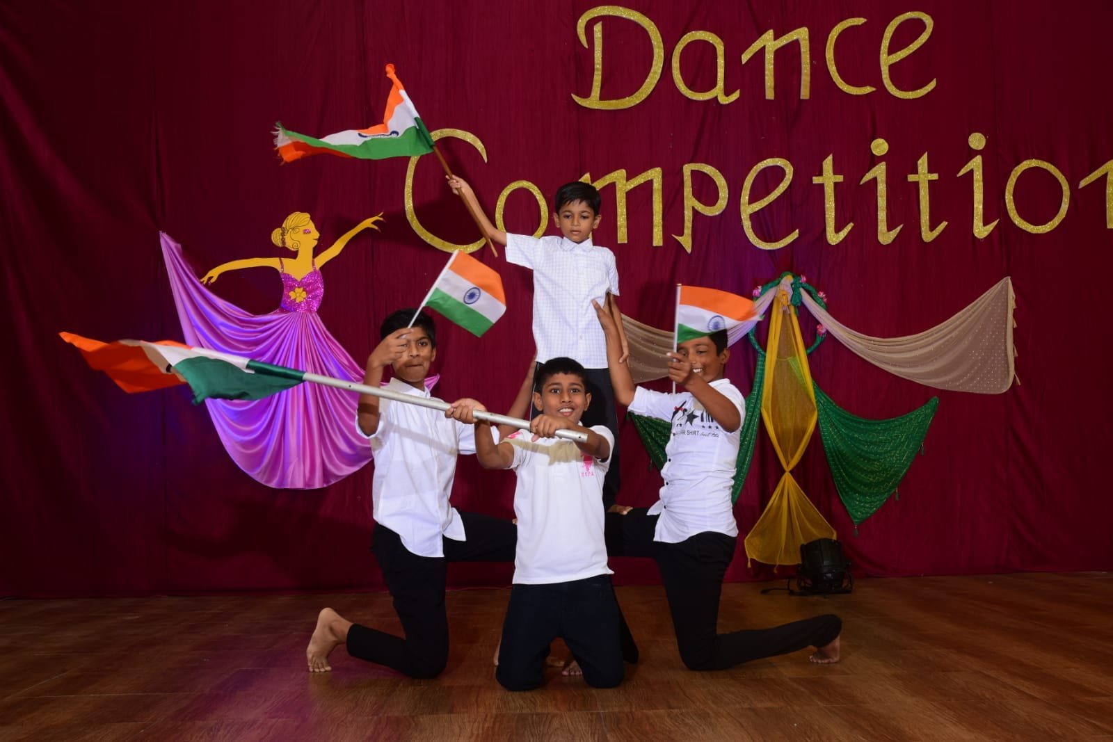 Students performing a patriotic dance with the Indian flag